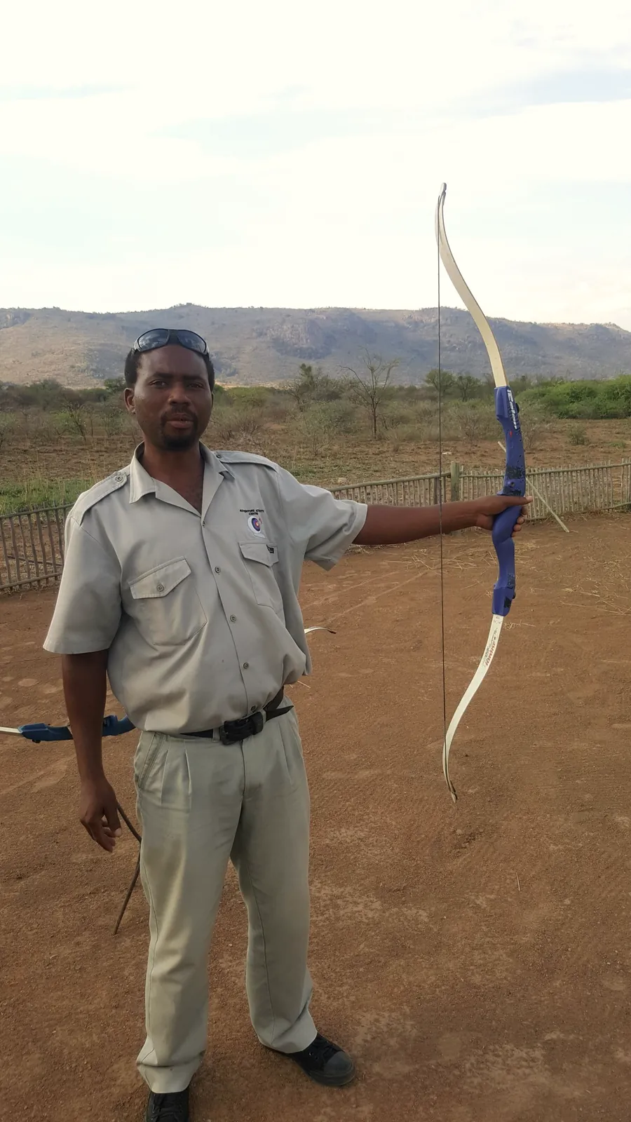 A Tautona instructor holding a recurve bow at the range
