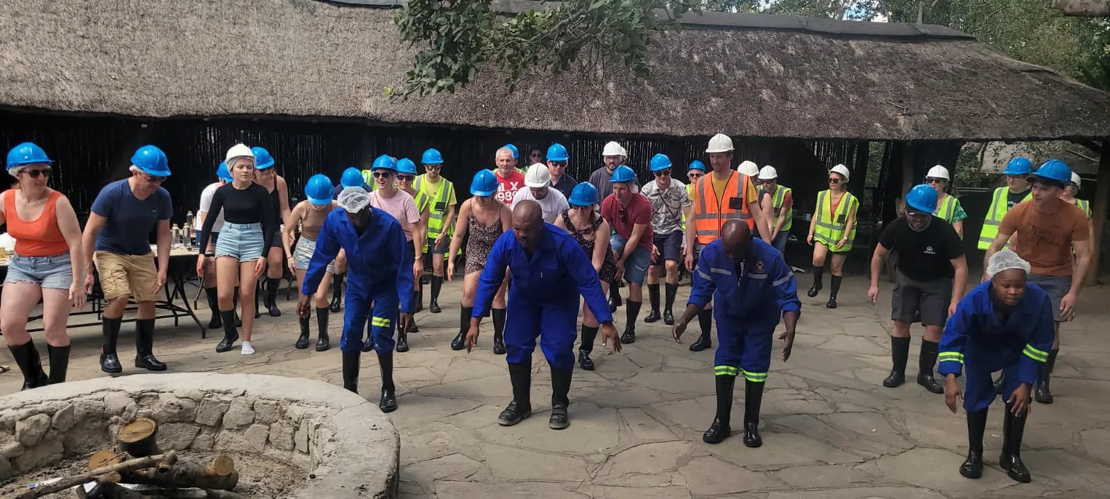A corporate group in hard hats and overalls at a Tautona team day