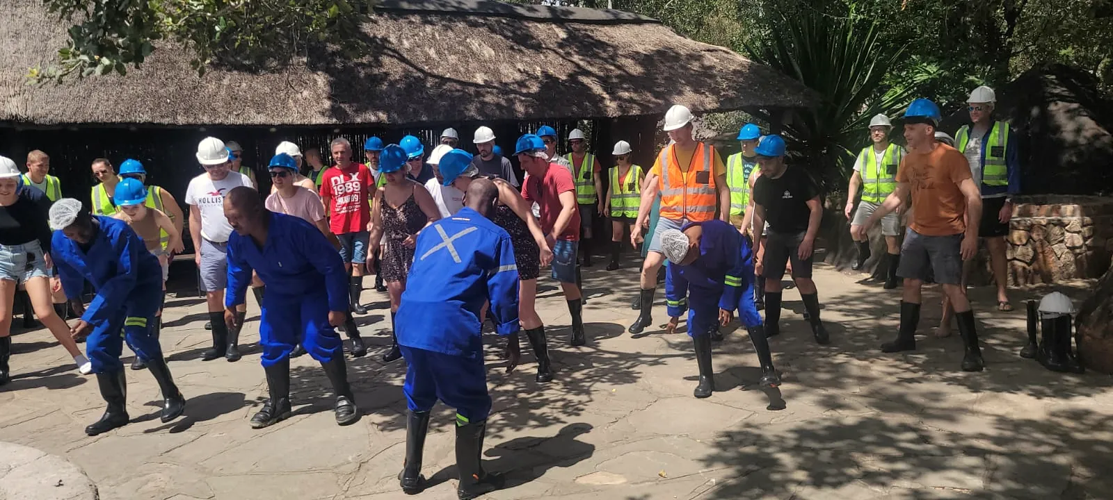 A corporate group warming up under thatch