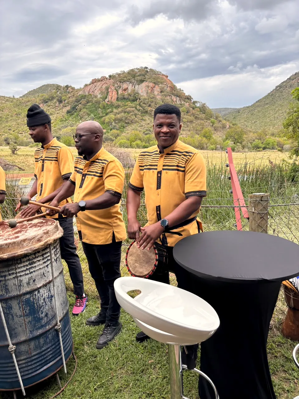 Drummers performing below the hills