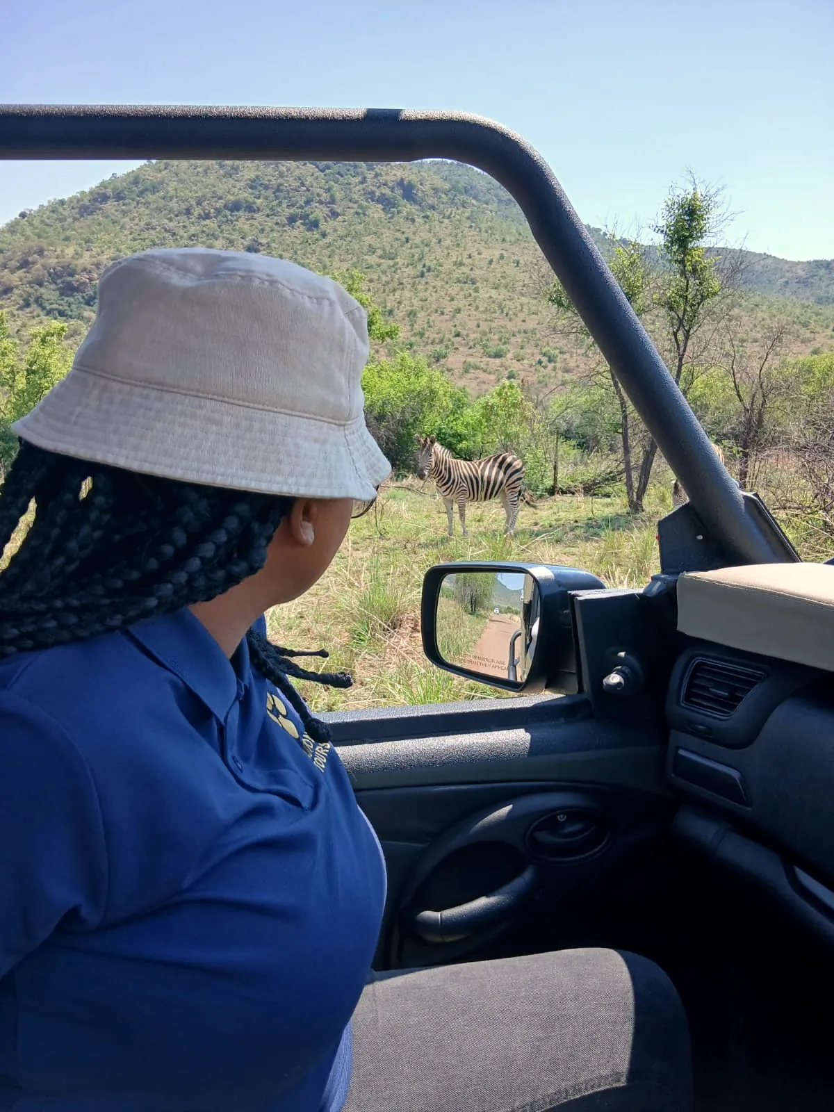 A guest on a Tautona game drive looking out over the bushveld