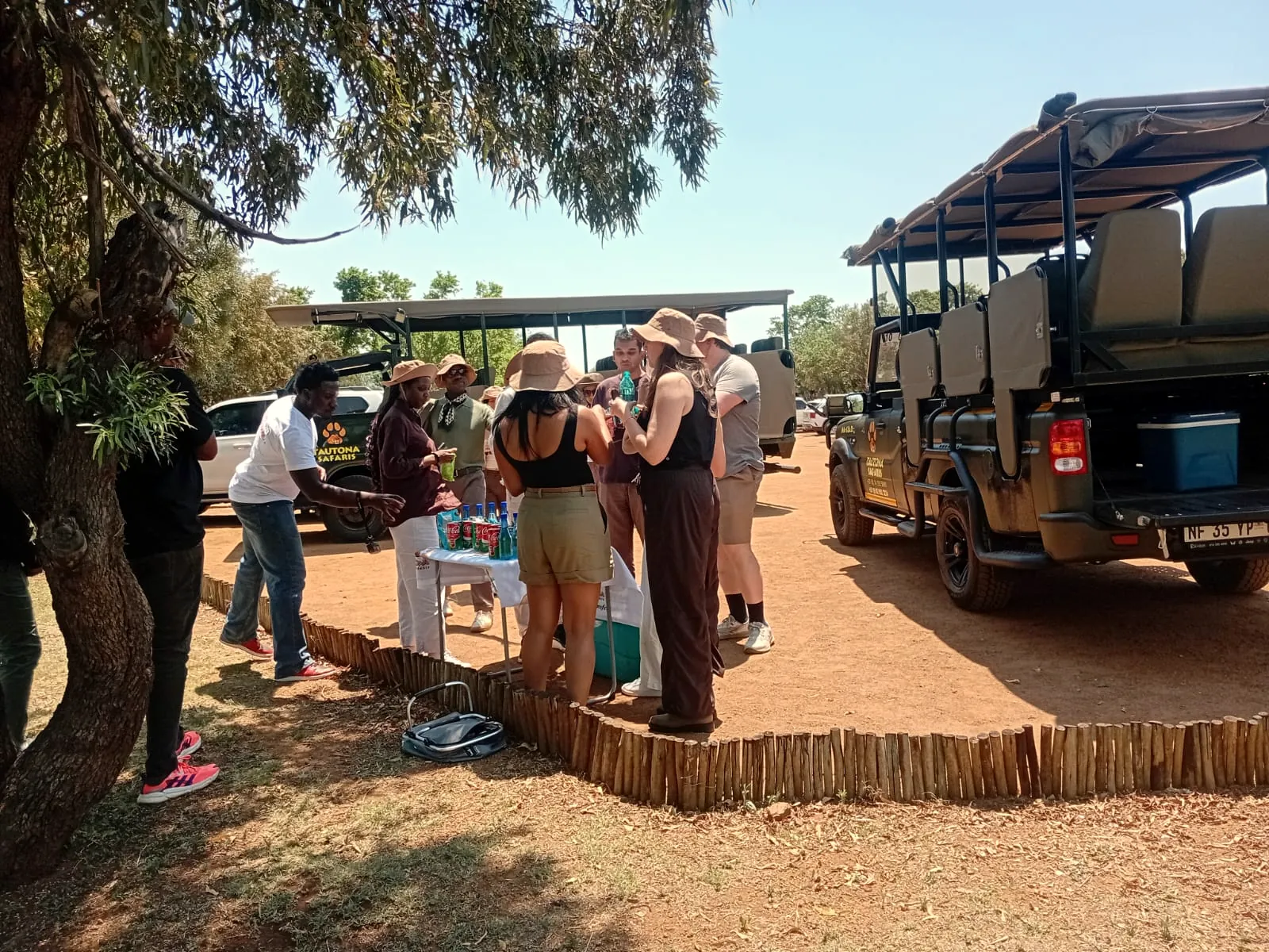 Guests at a bush stop beside the game vehicle