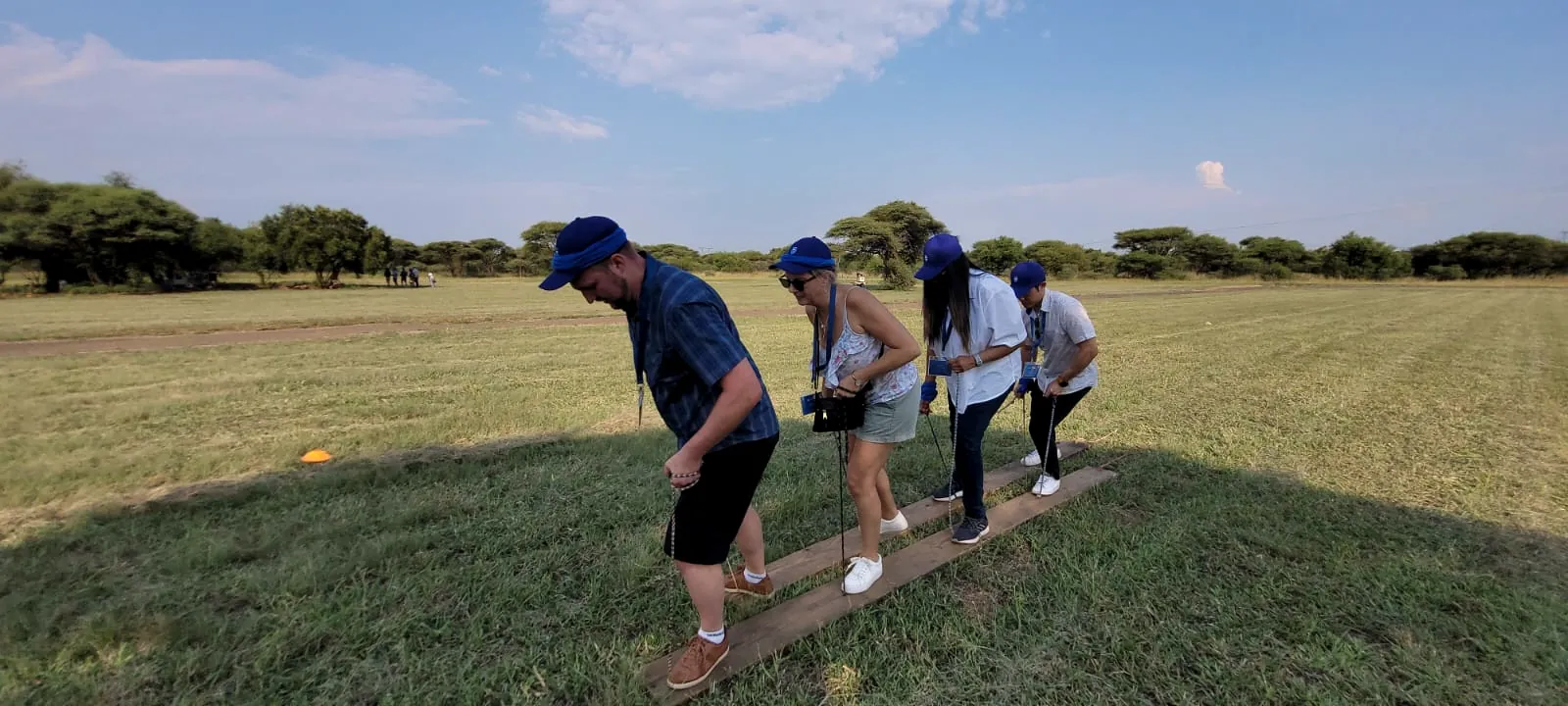 A team walking in step on shared planks