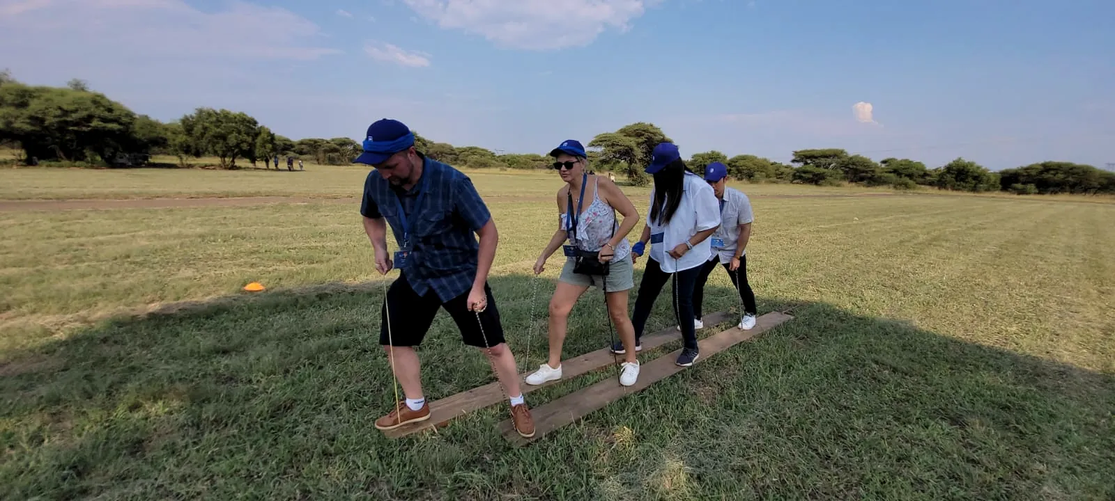 Team walking in step on shared planks