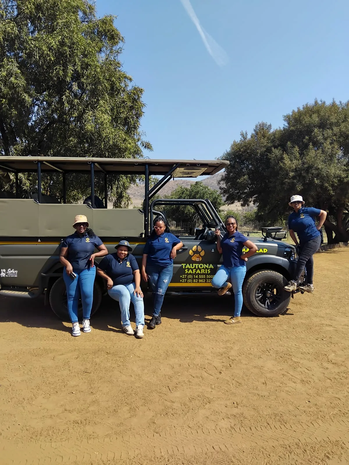 The Tautona team in front of a Tautona safari vehicle